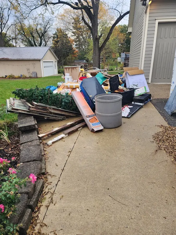 Dumpster being loaded with debris for Estate Cleanout Dumpster Rental in Desert Hills